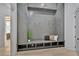 Grey mud room with a built-in bench, storage cubbies, and coat hooks for organization and convenience at 115 Nova Lane, Roswell, GA 30075