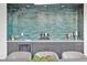 Wet bar with turquoise brick backsplash, gray cabinetry, white countertops and silver decorative items at 115 Nova Lane, Roswell, GA 30075