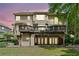 Backyard view featuring a multi-level deck and lush landscaping in a serene setting at 1415 Liberty Ln, Cumming, GA 30040