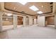 Finished basement with decorative tile ceiling, neutral colors, and access to additional rooms at 1415 Liberty Ln, Cumming, GA 30040