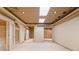 Open basement space with finished ceiling and access to other rooms at 1415 Liberty Ln, Cumming, GA 30040