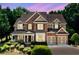 Charming two-story brick home featuring manicured landscaping and a two-car garage at 1415 Liberty Ln, Cumming, GA 30040
