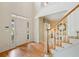 Welcoming foyer with hardwood floors, staircase and views into the adjacent living spaces at 1415 Liberty Ln, Cumming, GA 30040