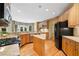Spacious kitchen with granite countertops, stainless steel appliances, a center island, and wood floors at 1415 Liberty Ln, Cumming, GA 30040