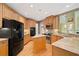 Well-equipped kitchen featuring granite counters, stainless steel appliances, wood floors, and ample storage at 1415 Liberty Ln, Cumming, GA 30040