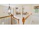 Bright open loft featuring wood railings, decorative chandelier and ample natural light at 1415 Liberty Ln, Cumming, GA 30040
