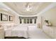 A spacious main bedroom offers plush carpet, a tray ceiling, and natural light from the windows at 1415 Liberty Ln, Cumming, GA 30040