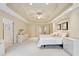 Large main bedroom with ensuite bathroom, neutral colors, plush carpet and ceiling fan at 1415 Liberty Ln, Cumming, GA 30040