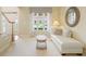 Comfortable sitting area with plush seating, round mirror and lots of natural light at 1415 Liberty Ln, Cumming, GA 30040