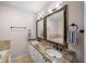 Double vanity bathroom with granite countertops, decorative mirrors and modern fixtures at 1735 Peachtree Ne St # 117, Atlanta, GA 30309