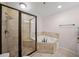 Bright bathroom featuring a glass enclosed shower and a separate soaking tub at 1735 Peachtree Ne St # 117, Atlanta, GA 30309