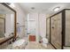 Well-lit bathroom featuring a glass-enclosed shower and a granite-topped single sink vanity at 1735 Peachtree Ne St # 117, Atlanta, GA 30309