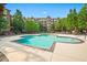 Large community swimming pool with lounge chairs, surrounded by lush landscaping and well-maintained grounds at 1735 Peachtree Ne St # 117, Atlanta, GA 30309
