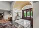 Grand foyer with high ceilings, decorative tile flooring, a statement mirror, and glass-paneled front doors at 1735 Peachtree Ne St # 117, Atlanta, GA 30309