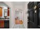Inviting entrance with archway detail, black door, and views of the kitchen, hardwood floors, and living room at 1735 Peachtree Ne St # 117, Atlanta, GA 30309