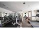 Well-equipped home gym with modern exercise machines, mirrored walls, and plenty of natural light at 1735 Peachtree Ne St # 117, Atlanta, GA 30309