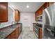 Galley kitchen with stainless appliances, granite counters, and tiled flooring at 1735 Peachtree Ne St # 117, Atlanta, GA 30309
