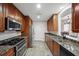 Galley kitchen featuring stainless steel appliances and granite countertops at 1735 Peachtree Ne St # 117, Atlanta, GA 30309