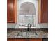 Charming kitchen pass-through to the living room with granite countertops and a stainless steel sink at 1735 Peachtree Ne St # 117, Atlanta, GA 30309