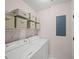 Laundry room including a washer, dryer, storage shelves and an electrical panel at 1735 Peachtree Ne St # 117, Atlanta, GA 30309