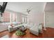 Bright living room with large gray sectional, hardwood floors, and plenty of natural light at 1735 Peachtree Ne St # 117, Atlanta, GA 30309