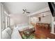 Open floor plan with hardwood floors and gray sectional sofa, with access to dining area at 1735 Peachtree Ne St # 117, Atlanta, GA 30309