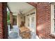 Outdoor patio featuring a brick railing, ceiling fan, and a table with four chairs at 1735 Peachtree Ne St # 117, Atlanta, GA 30309