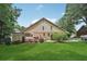 Expansive backyard showcasing a lush lawn, mature trees, and a charming deck with outdoor seating at 2011 Sturbridge Ln, Buford, GA 30519
