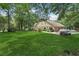 Lush backyard with expansive lawn, mature trees and a charming deck, perfect for outdoor activities at 2011 Sturbridge Ln, Buford, GA 30519