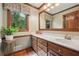 Bathroom featuring double vanity with wooden cabinets and large mirror at 2011 Sturbridge Ln, Buford, GA 30519