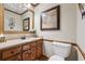 Traditional bathroom with wood cabinetry, granite countertop, and decorative accents at 2011 Sturbridge Ln, Buford, GA 30519