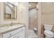 Bright bathroom with white cabinetry, glass-enclosed shower, and stylish finishes at 2011 Sturbridge Ln, Buford, GA 30519