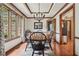 Cozy dining room with natural light, hardwood floors, and an elegant chandelier at 2011 Sturbridge Ln, Buford, GA 30519