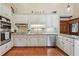 Modern kitchen with white cabinets, stainless steel appliances, and a tiled backsplash at 2011 Sturbridge Ln, Buford, GA 30519