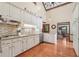 Bright kitchen features white cabinets, granite countertops, and stainless steel appliances at 2011 Sturbridge Ln, Buford, GA 30519