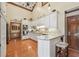 Bright kitchen featuring white cabinetry, modern appliances, and hardwood floors at 2011 Sturbridge Ln, Buford, GA 30519