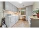 Well-lit laundry room with modern washer and dryer, cabinets, granite countertop and natural light at 2011 Sturbridge Ln, Buford, GA 30519