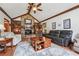 Living room featuring stone fireplace, vaulted ceiling, and hardwood floors at 2011 Sturbridge Ln, Buford, GA 30519
