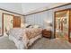 Bedroom featuring a tray ceiling and an doorway leading to the en suite and hallway at 2011 Sturbridge Ln, Buford, GA 30519