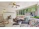 Relaxing sunroom with ceiling fan, rocking chair and comfortable seating perfect for enjoying the outdoors at 2011 Sturbridge Ln, Buford, GA 30519