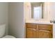 Bathroom with a single oak vanity, light countertop and fixtures, and a standard toilet at 2191 Phillips Rd, Lithonia, GA 30058