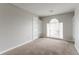 Bedroom featuring neutral walls and carpet, and built-in shelves surrounding a arched window at 2191 Phillips Rd, Lithonia, GA 30058