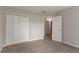 Bedroom featuring neutral paint and carpet with an open white door and closet at 2191 Phillips Rd, Lithonia, GA 30058