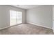 Bedroom with neutral paint and carpet with natural light from a window with white blinds at 2191 Phillips Rd, Lithonia, GA 30058