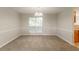 Spacious dining area with new carpet and a large window, adjacent to the kitchen at 2191 Phillips Rd, Lithonia, GA 30058
