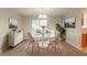 Modern dining room with stylish white furniture and decor, bathed in natural light at 2191 Phillips Rd, Lithonia, GA 30058