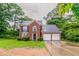 Charming two-story brick home featuring a two-car garage and well-maintained front lawn at 2191 Phillips Rd, Lithonia, GA 30058