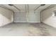 Two-car garage featuring concrete flooring and two white garage doors at 2191 Phillips Rd, Lithonia, GA 30058