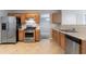 Traditional kitchen featuring stainless steel appliances, wooden cabinets, and durable laminate flooring at 2191 Phillips Rd, Lithonia, GA 30058