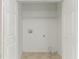 A laundry closet with bi-fold doors with hookups and tile floor at 2191 Phillips Rd, Lithonia, GA 30058